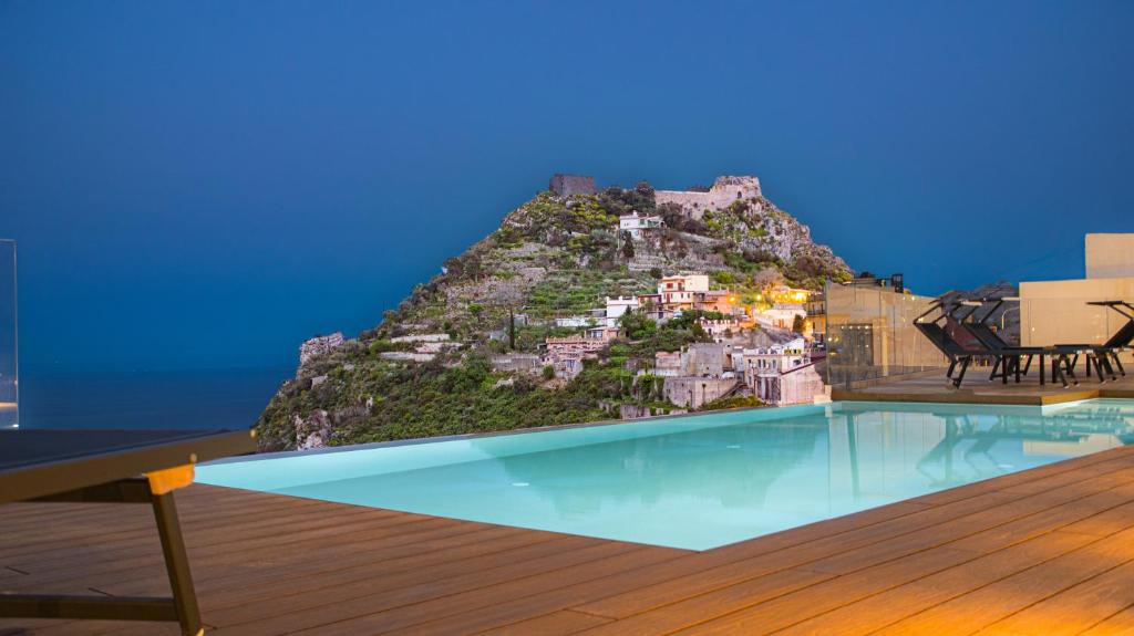 a view of a mountain with a swimming pool at The View Luxury Apartments Taormina in Taormina