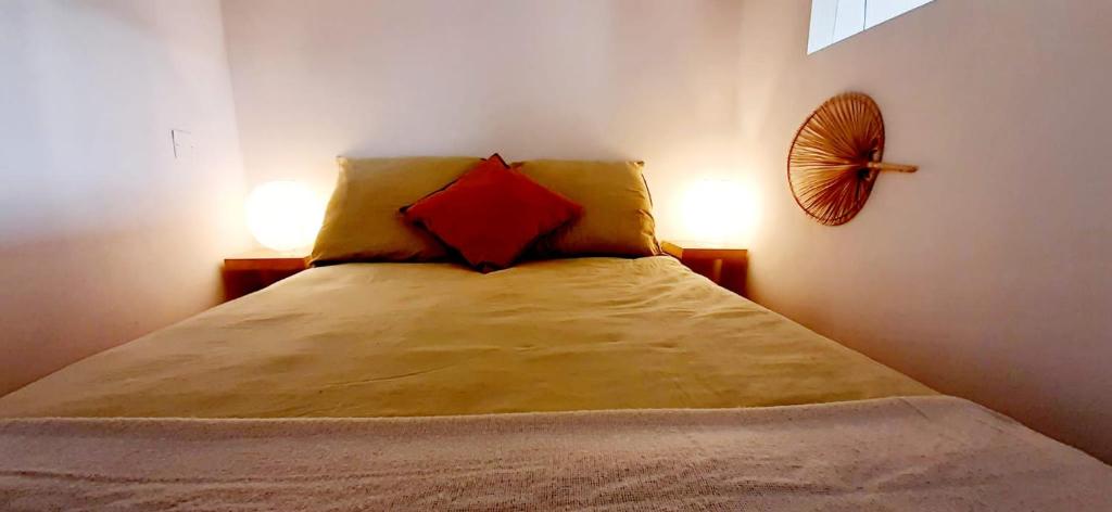 a bedroom with a bed with two pillows on it at Appartement avec terrasse in Toulon