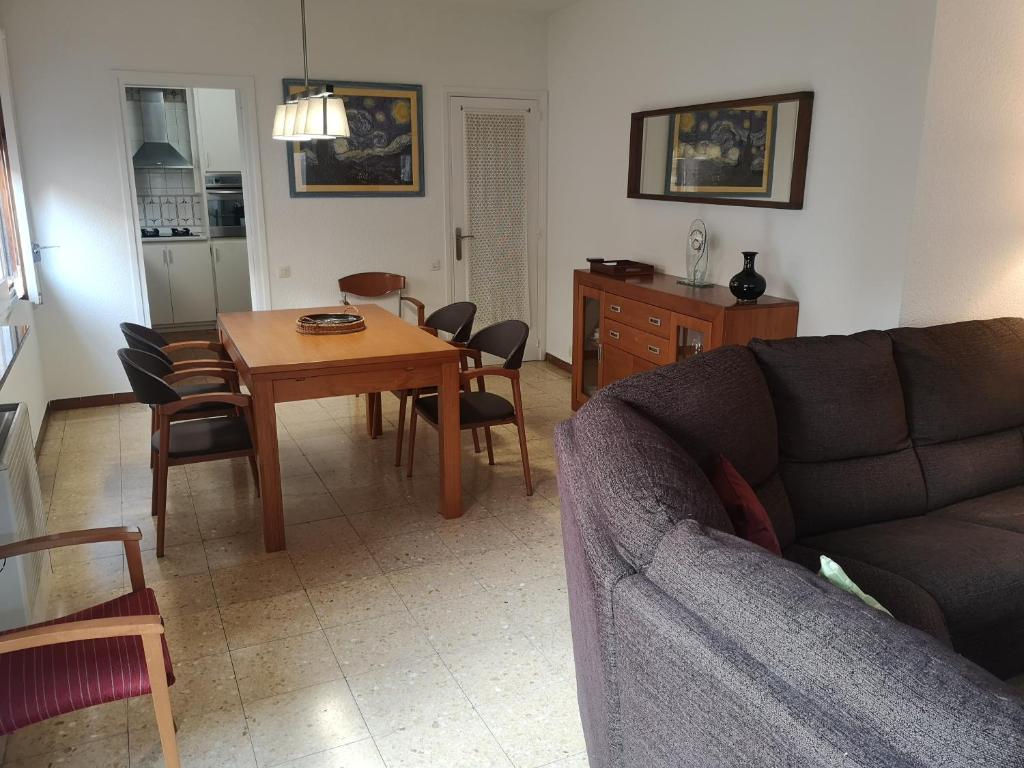 a living room with a couch and a table at Apartamento duplex vacacional in Arenys de Mar