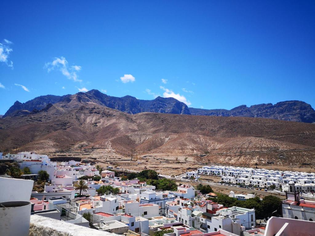 uitzicht op een stad met bergen op de achtergrond bij Casa Tamadaba Agaete in Agaete