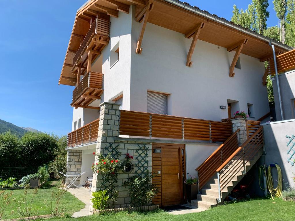 a house with wooden balconies on the side of it at Shangry-la in Briançon