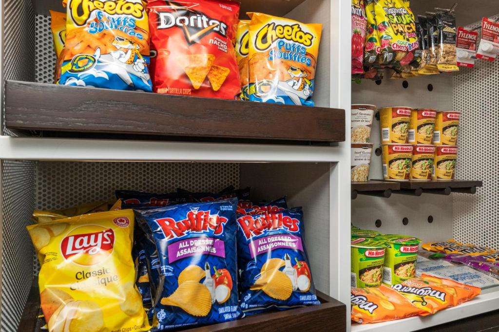 a refrigerator filled with lots of different types of chips at Comfort Inn in Ottawa