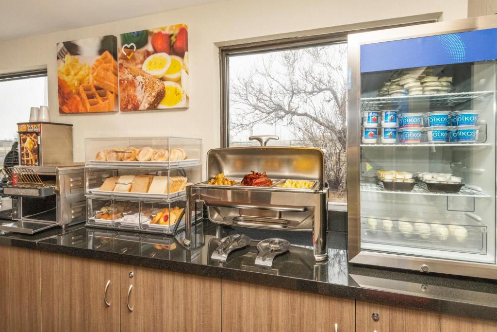 a kitchen with a buffet with food on a counter at Comfort Inn in Ottawa
