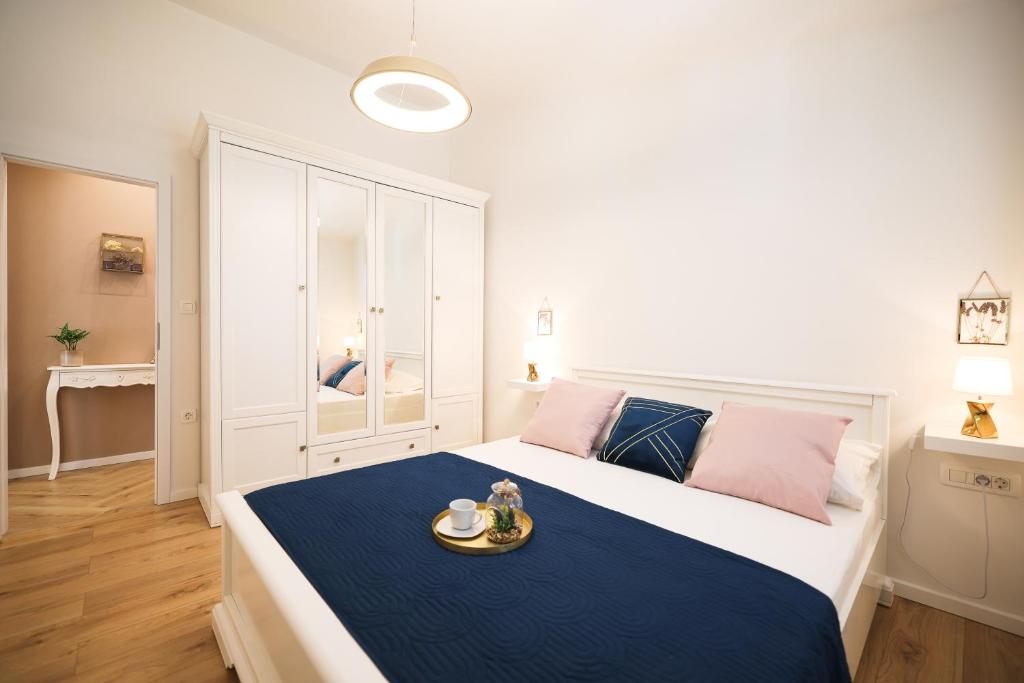 a bedroom with a large bed with a tray on it at Apartments Marta in Verunić