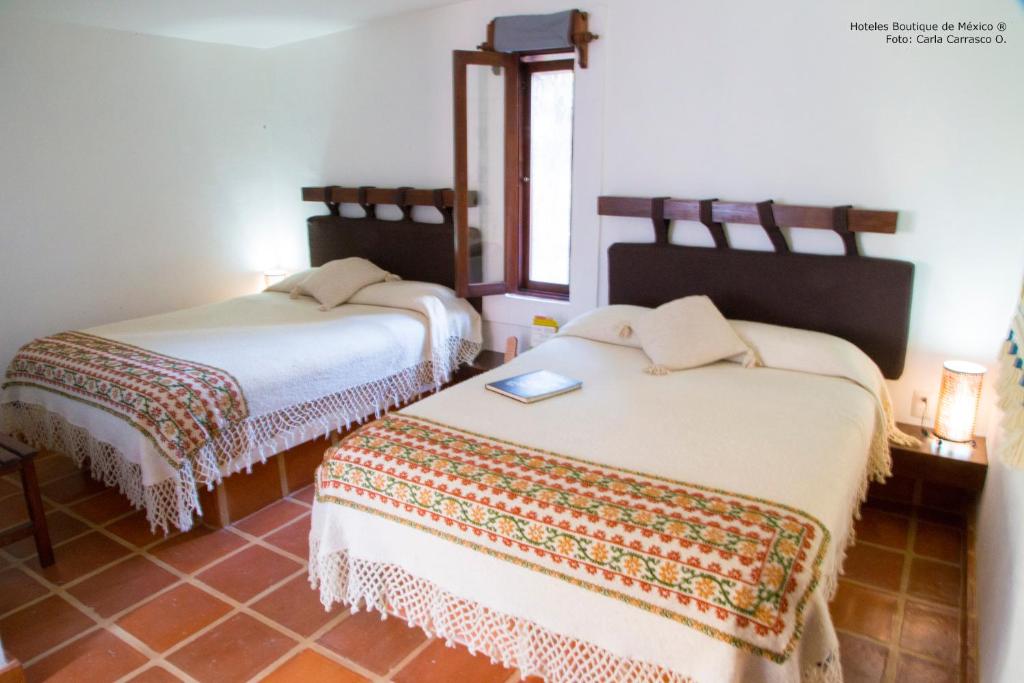 Postel nebo postele na pokoji v ubytování El Cantar del Viento- Hotel Boutique