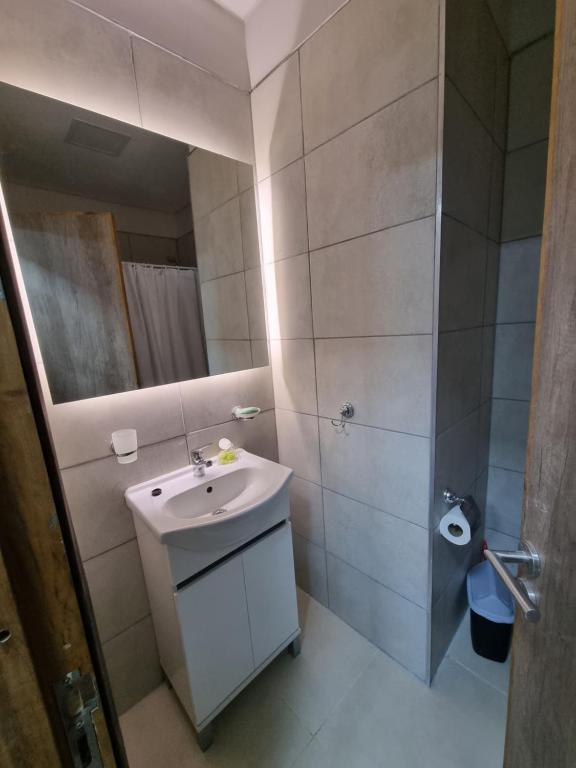 a small bathroom with a sink and a mirror at Departamento en Luján de Cuyo in Ciudad Lujan de Cuyo