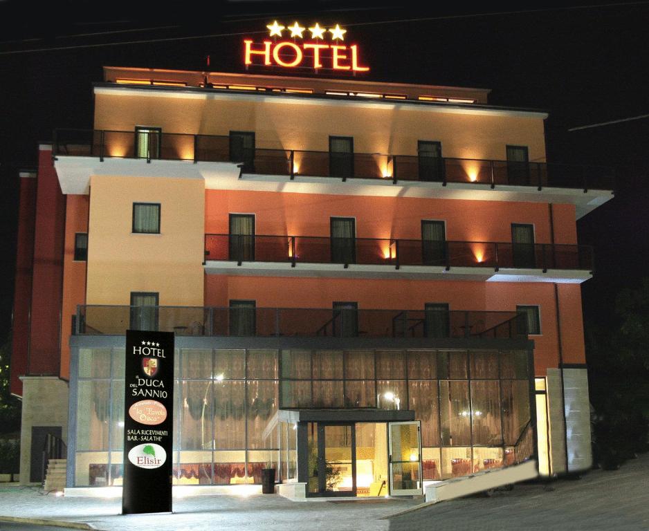 a hotel with a sign on top of it at night at Hotel Il Duca Del Sannio in Agnone