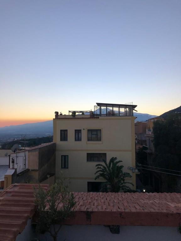 a building with a balcony on top of it at Taormina Center Private Apartments By Fragranza Di Sicilia in Taormina