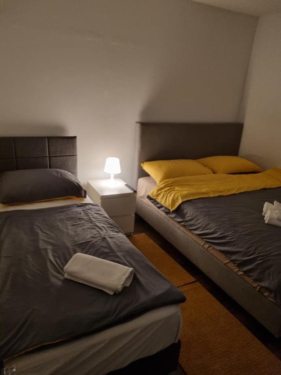 two beds sitting next to each other in a bedroom at Apartman Migliore in Sesvete