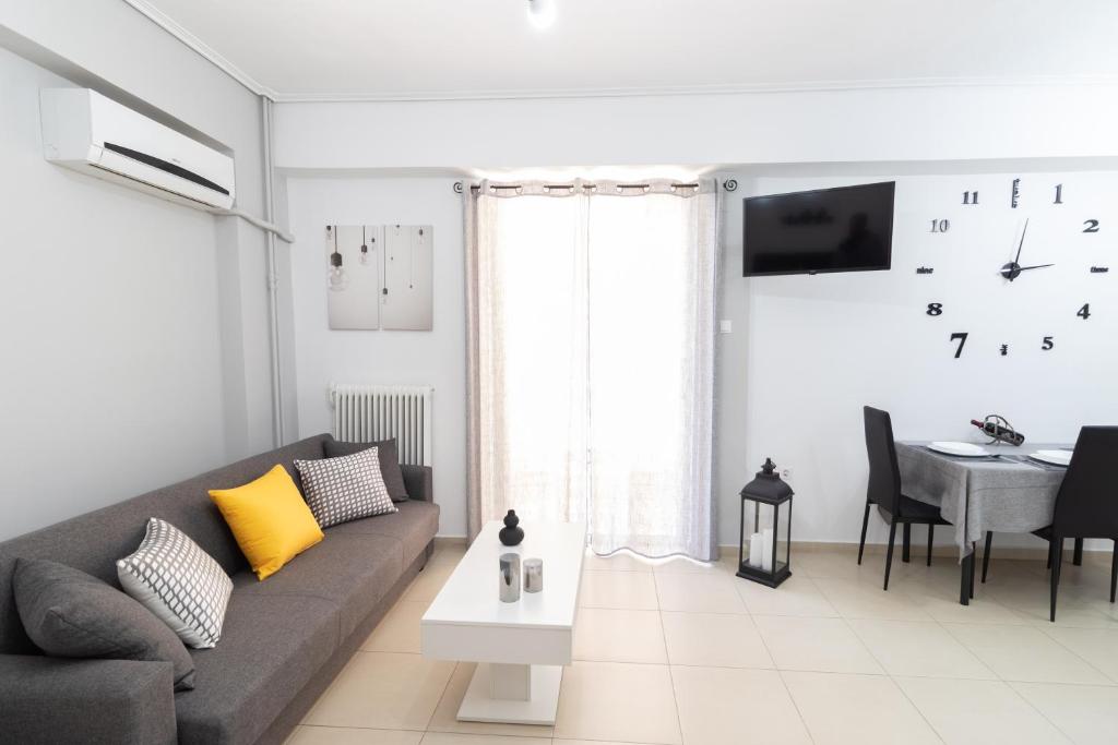 a living room with a gray couch and a table at C3 Modern Spartan Apartment in Sparti