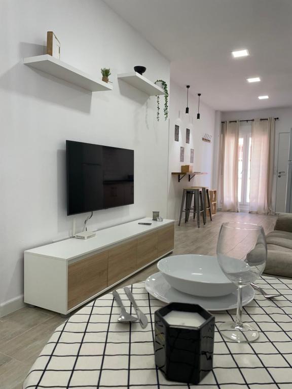 a living room with a television and a table and chair at Apartamento Tarifa Sunset in Tarifa