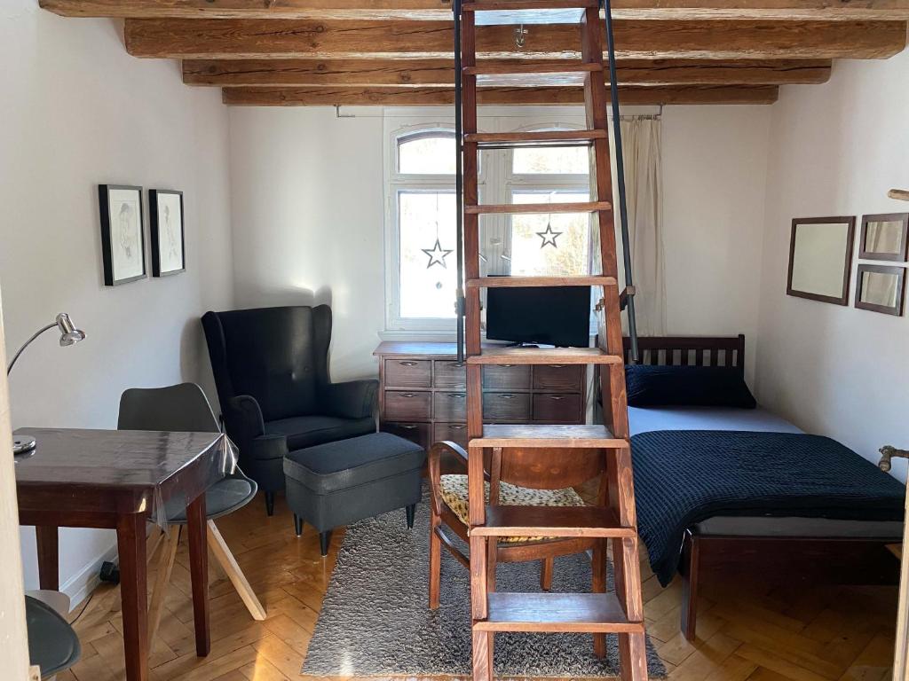 a room with a loft bed with a desk and a chair at Privatzimmer Leopold in Sigmaringen