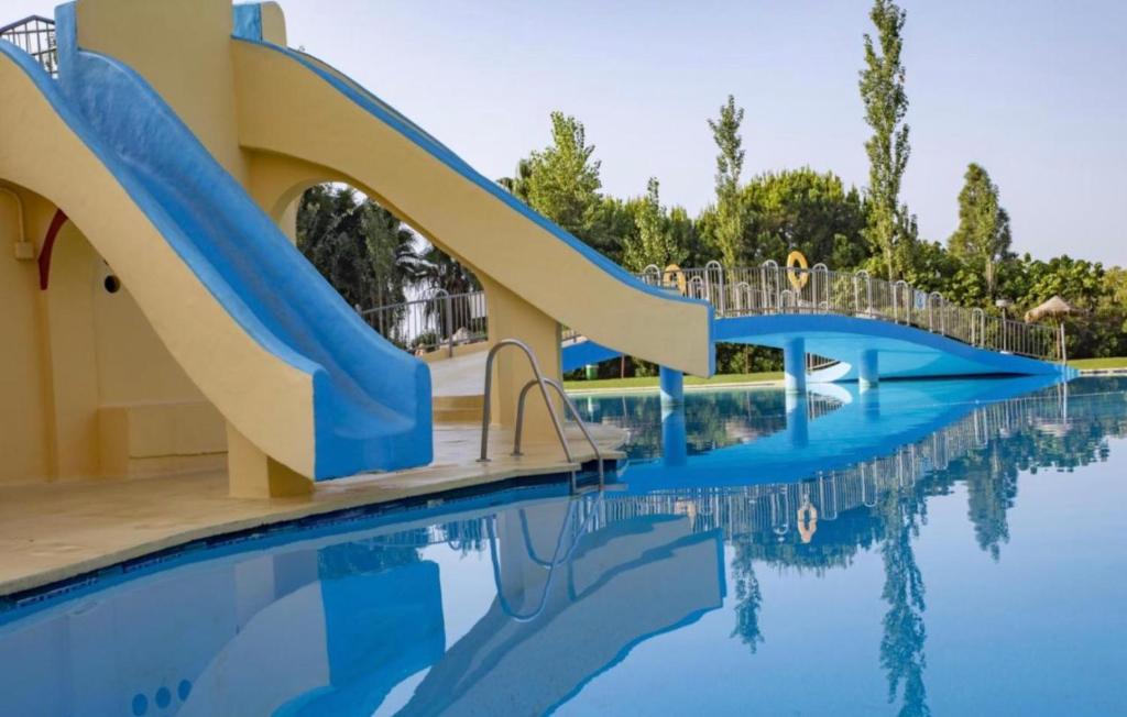 a slide in a pool at a resort at Aparthotel Minerva in Benalmádena