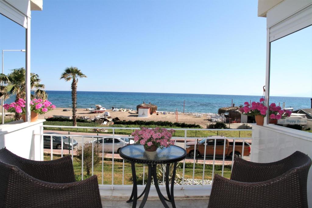 a patio with a table and chairs and the ocean at Уютная квартира на берегу моря с частным бесплантным пляжем in Antalya