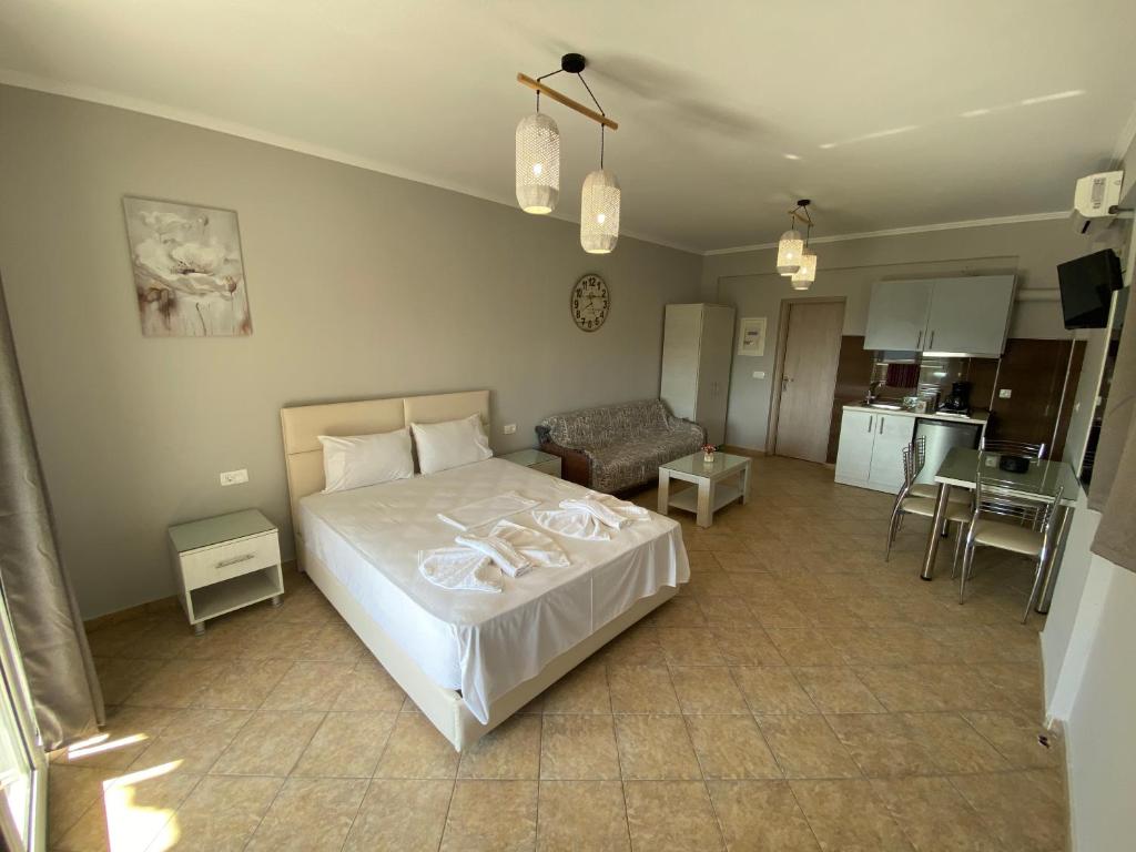 a bedroom with a bed and a living room at Home Apartments in Parga