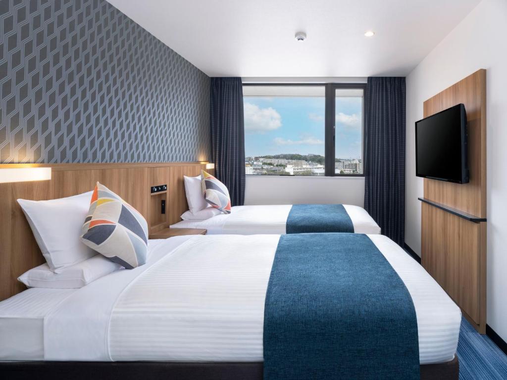 Postel nebo postele na pokoji v ubytování HOTEL MYSTAYS Soga