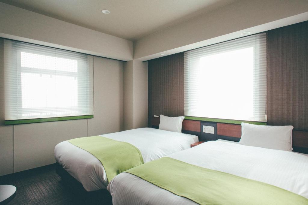 เตียงในห้องที่ Hotel Kuretakeso Takayama Ekimae