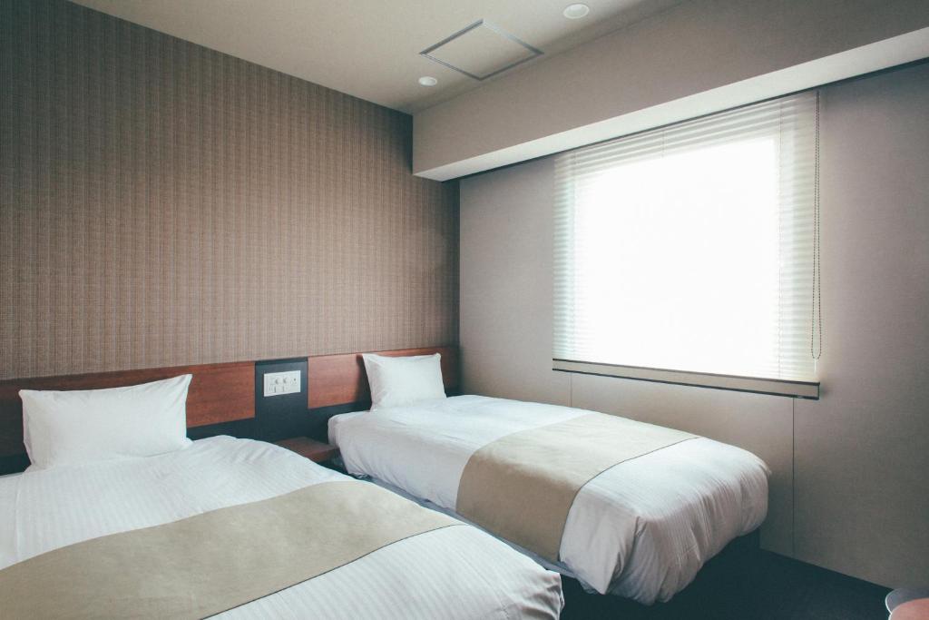 เตียงในห้องที่ Hotel Kuretakeso Takayama Ekimae