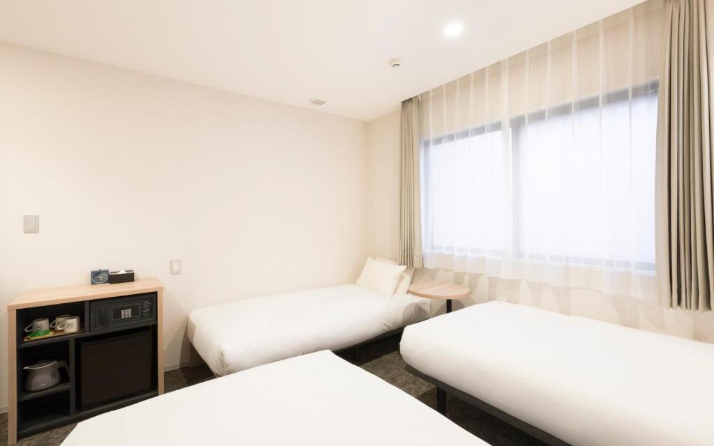 Postel nebo postele na pokoji v ubytování M's Hotel Sanjo Omiya