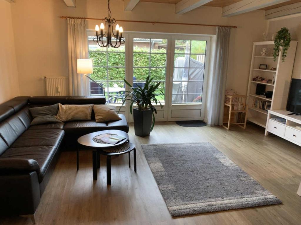 ein Wohnzimmer mit einem Sofa und einem Tisch in der Unterkunft Huus Utspann in Nordstrand
