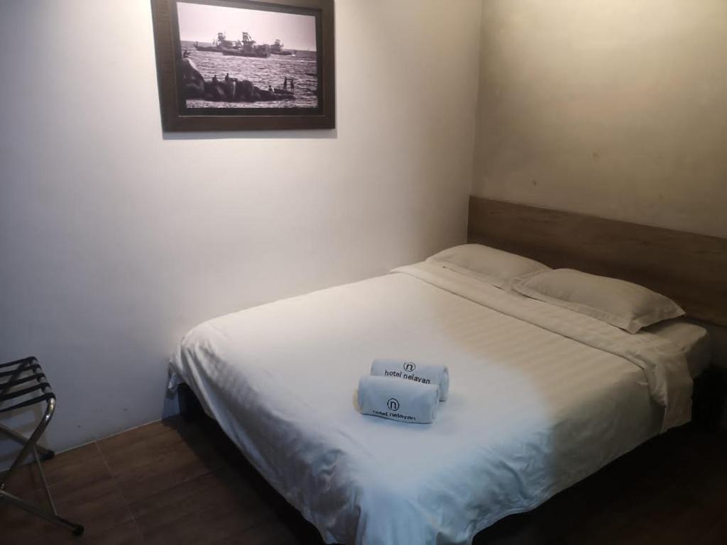 Postel nebo postele na pokoji v ubytování Hotel Nelayan