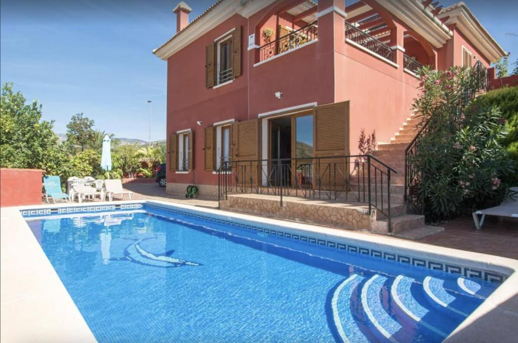 a swimming pool in front of a house at Casa Meli in Finestrat