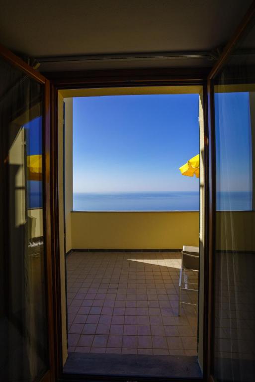a view of a room with a view of the ocean at Albergo Luna di Marzo in Volastra
