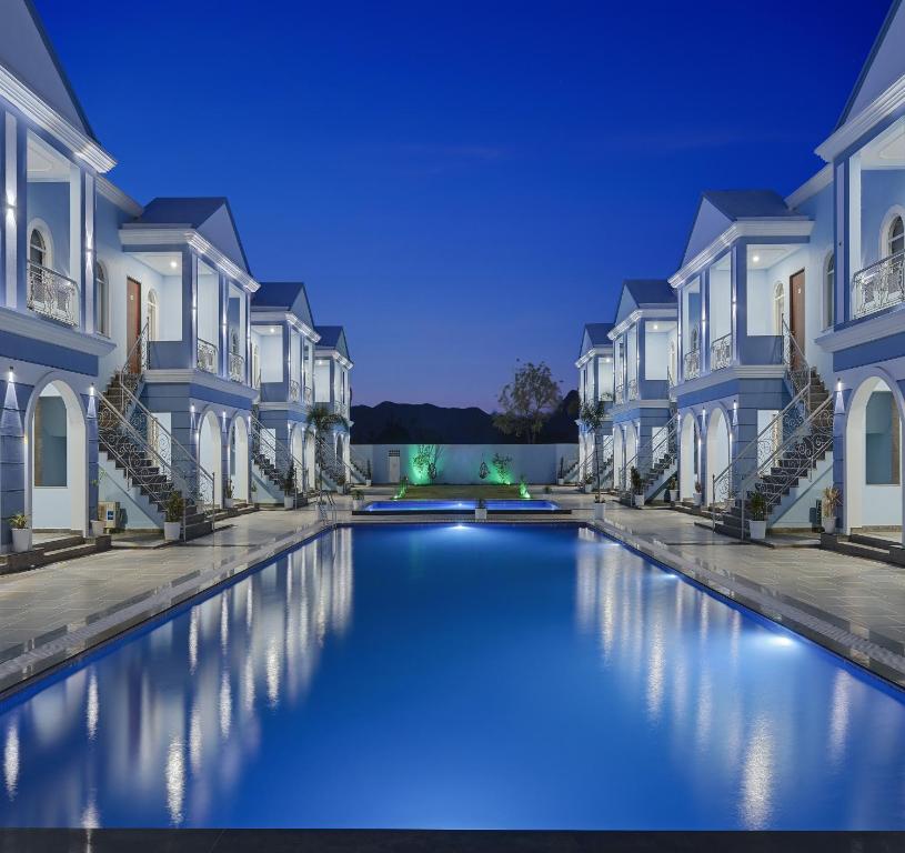 a rendering of a canal between houses at night at Red Tullip MD Valley Resort and Spa in Udaipur