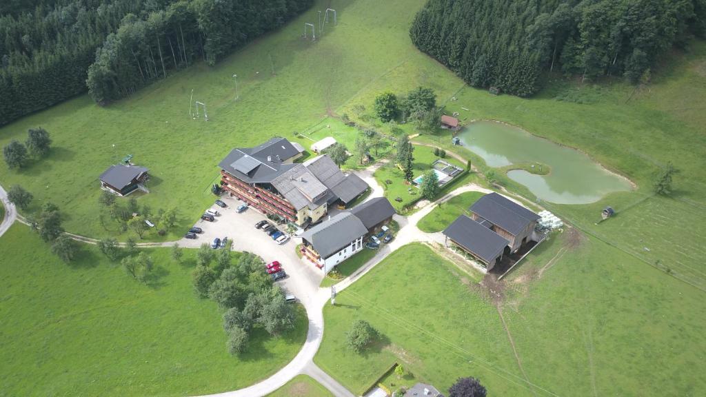 an aerial view of a house in a field at Gasthofladen Schneeweiss in Attersee am Attersee