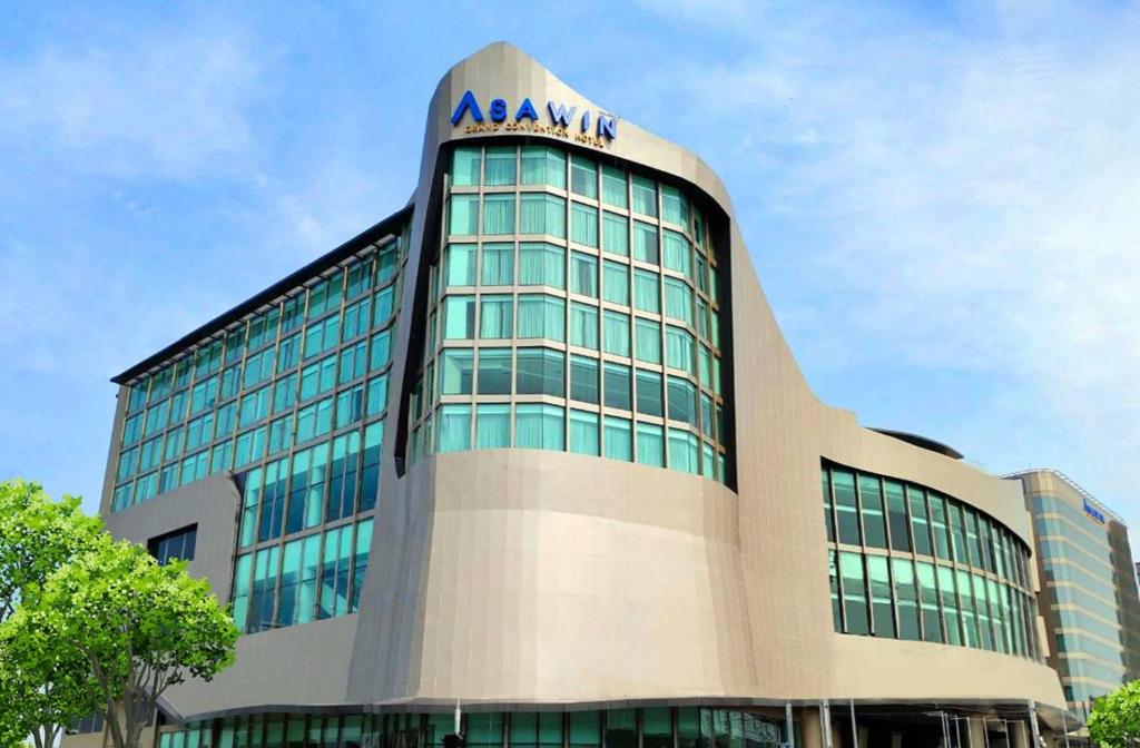 a building with aania sign on the top of it at Asawin Grand Convention Hotel in Bangkok