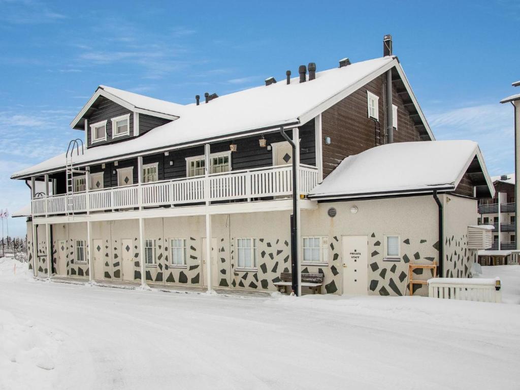 a large house with snow on the roof at Holiday Home Vaeltajankulma huoneisto 3 by Interhome in Ylläs