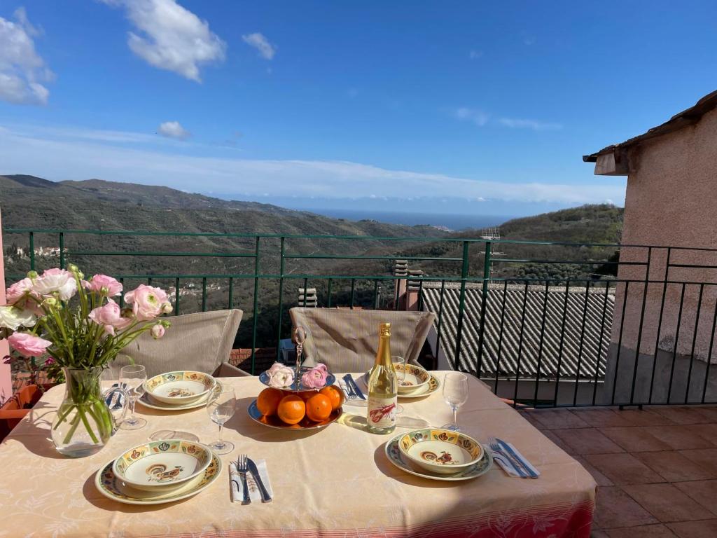 a table with plates of food and a bottle of wine at Apartment Le Volte by Interhome in Pantasina