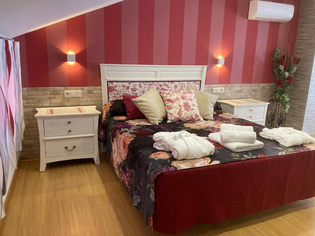 a bedroom with a bed with two pillows on it at Rosa Roja in El Barraco