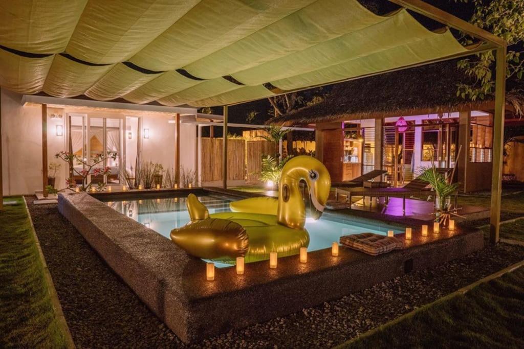 a swimming pool with a gold elephant in a house at Halamanan Residences in Panglao