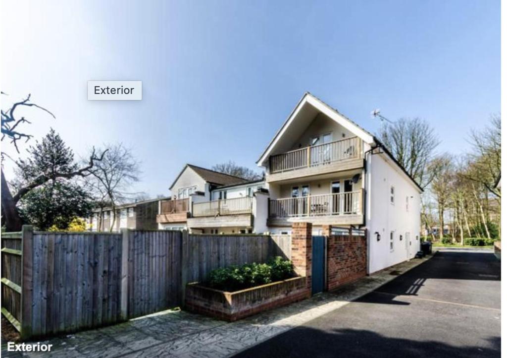 a house with a fence in front of it at 2-Bed Loft Apartment for 5ppl with private parking in Beckenham