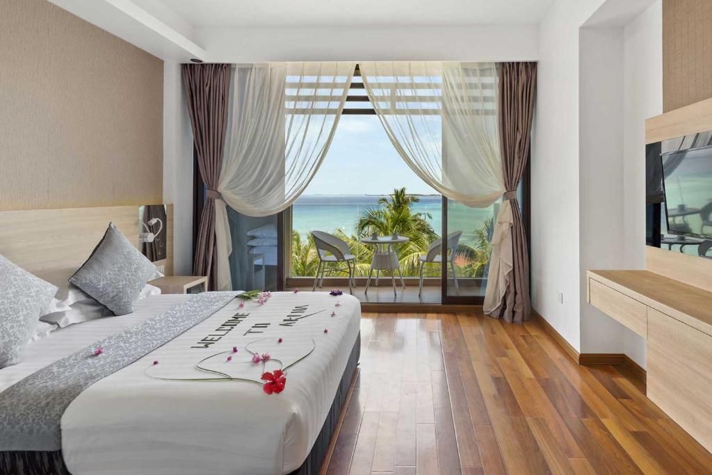 Postel nebo postele na pokoji v ubytování Arena Beach Hotel