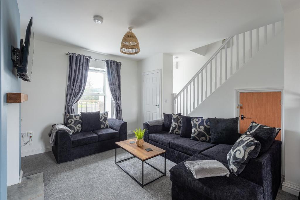 a living room with a couch and a table at Unique House - Leisure - Garden - Lake District in Wigton