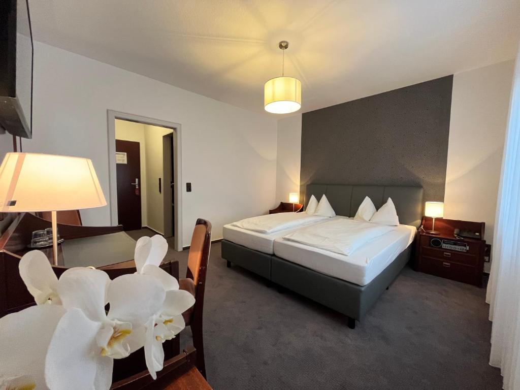 Postel nebo postele na pokoji v ubytování Hotel Garni Geisler
