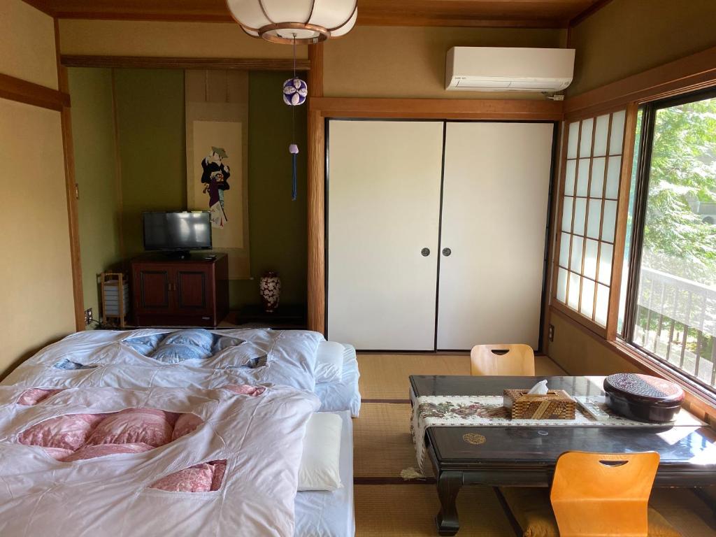 Postel nebo postele na pokoji v ubytování 宮城野ハウス＆離れ
