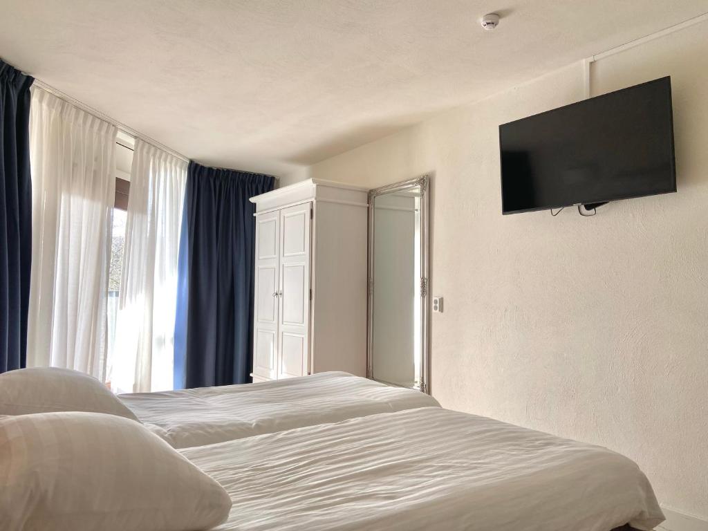Postel nebo postele na pokoji v ubytování Bed & Ontbijt Haddock