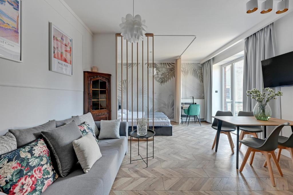 a living room with a couch and a table at Old Town by Welcome Apartment in Gdańsk