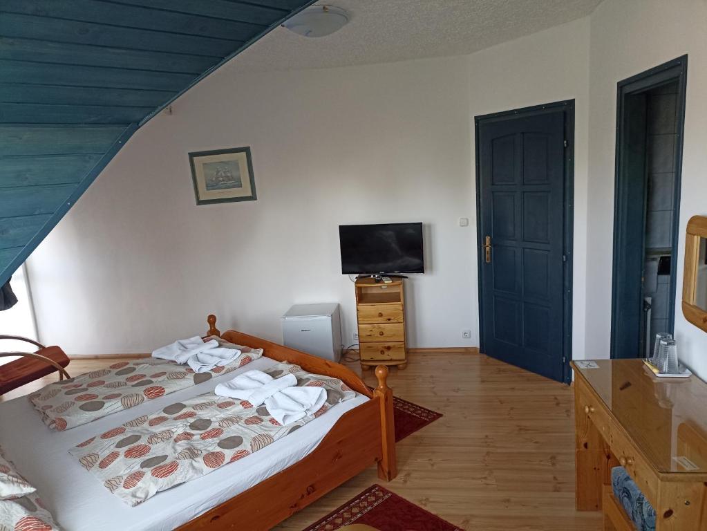 Postel nebo postele na pokoji v ubytování Muschel Panzió