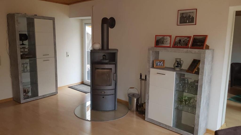 a living room with a wood stove in a room at Ferienwohnung Gersch in Wolf