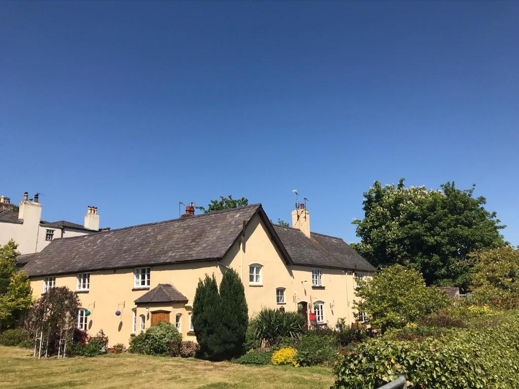 a large white house with a black roof at Oakenholt Farm Bed and Breakfast in Flint