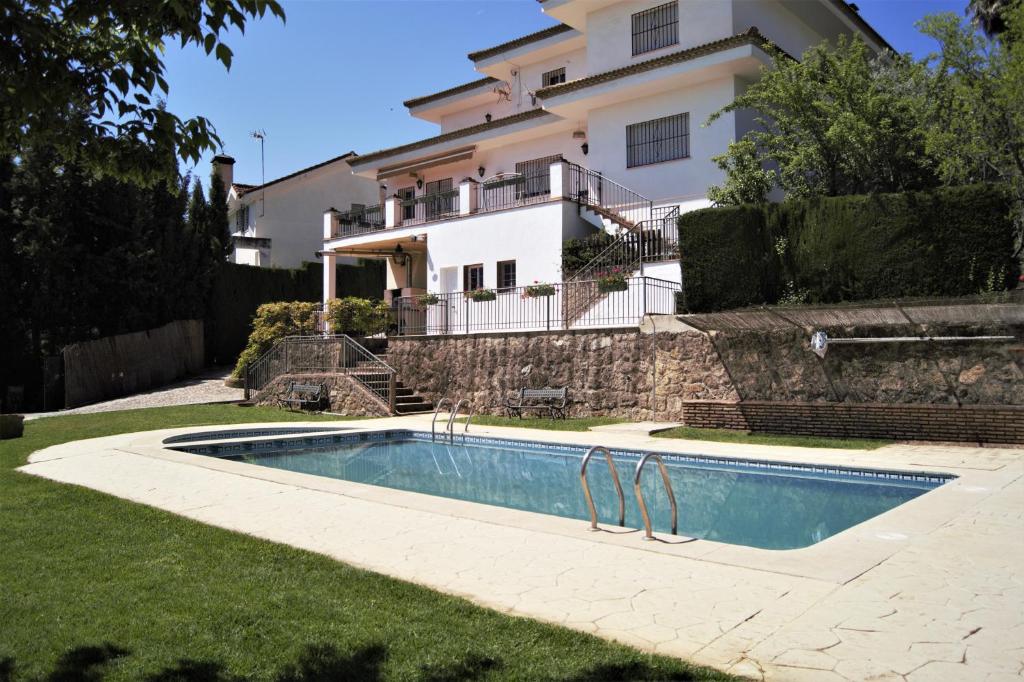 a house with a swimming pool in front of a house at San Francisco Javier in Córdoba