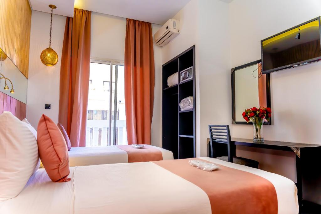 Postel nebo postele na pokoji v ubytování Hotel Les Ambassadeurs