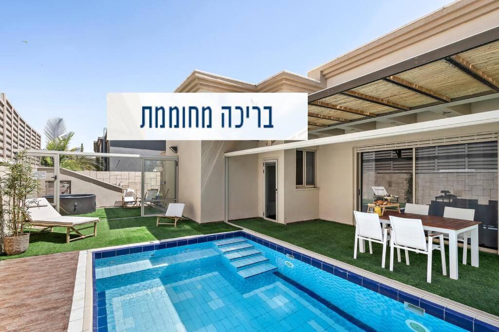 a villa with a swimming pool and a house at Perfect Villa in Beer Sheva