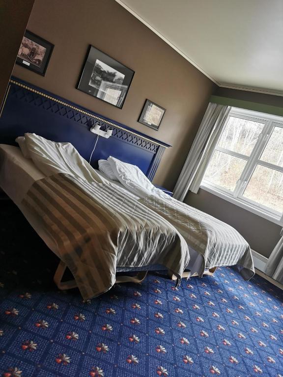 Postel nebo postele na pokoji v ubytování Grong Hotell