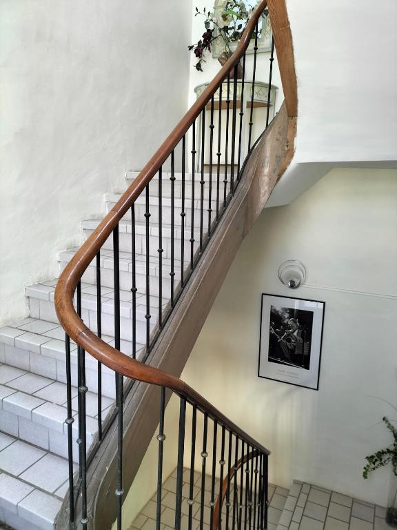 a staircase in a house with a wooden stair railing at Etablissement sorel in Saint-André-de-Sangonis