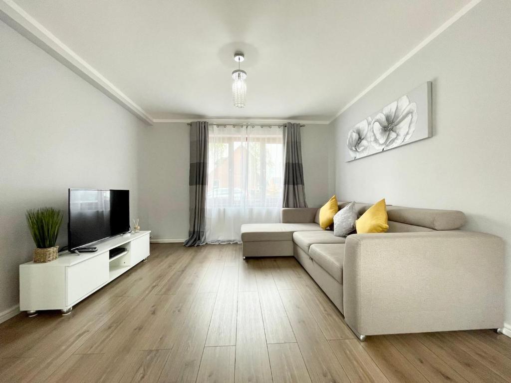 a living room with a couch and a television at Comfy 3-Bedroom House in Worksop in Worksop